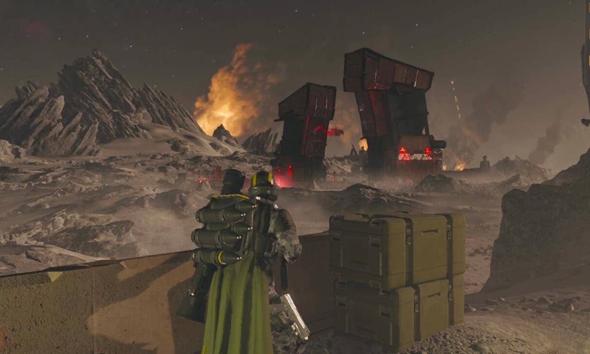 Helldivers 2 player looking at a fire from afar.